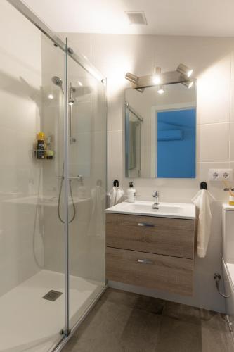 a bathroom with a shower and a sink and a mirror at Seamount, studio 3 mins from Tamariu beach in Tamariu