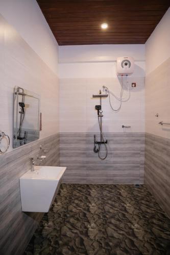 a bathroom with a sink and a shower at King coco villa in Tangalle