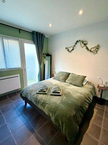 a bedroom with a bed with two plates on it at La Cascade in Sahurs