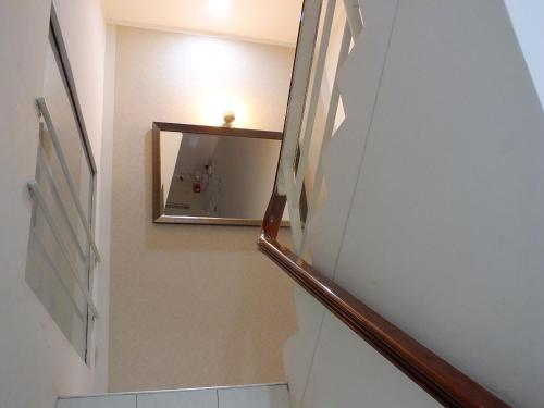 a stairway with a mirror on the wall at Hostal Gazu in Chiclayo