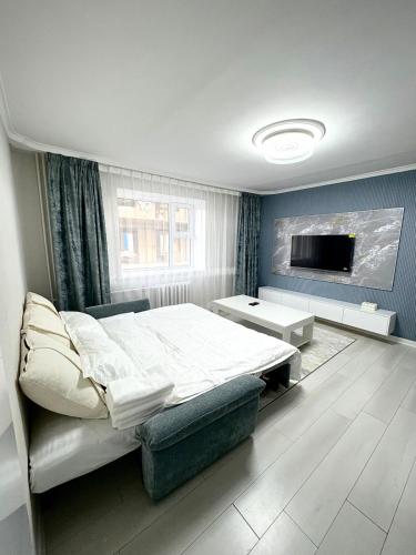 a bedroom with a large bed and a tv at Gegee's House in Ulaanbaatar