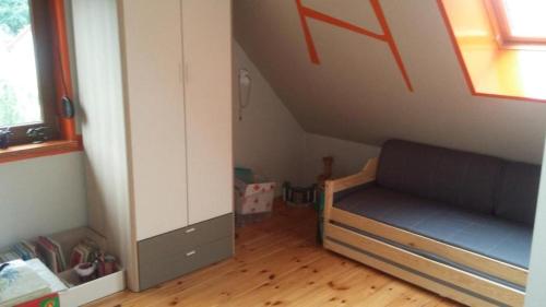 a room with a bunk bed in a attic at Familienurlaub am See - Haus nr 1 - Rokitki in Rokitki