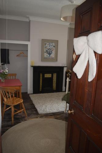 a living room with a bed and a fireplace at Gorffwysfa Hideaway Double 1st floor in Pwllheli