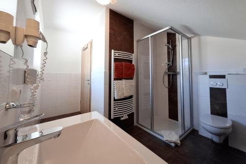 a bathroom with a tub and a shower and a toilet at Ferienhaus Wöscher in Kaltenbach
