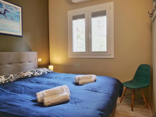 a bedroom with a blue bed with two pillows on it at Minerva - bilocale indipendente, posto auto e bici in Grado