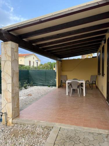 a patio with a table and chairs under awning at Residence Hydria in Campofelice di Roccella