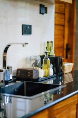 a kitchen counter with a sink and a microwave at Starico Residence in Nkoanrua