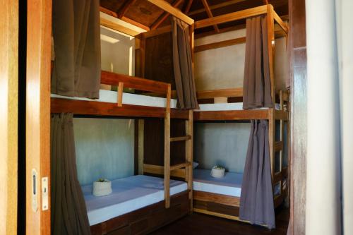 a room with two bunk beds in a house at Kayan Siargao in General Luna