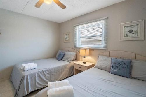 a bedroom with two beds and a window at Oceanfront Condo w Heated Pool & Reserved Parking in Wildwood Crest