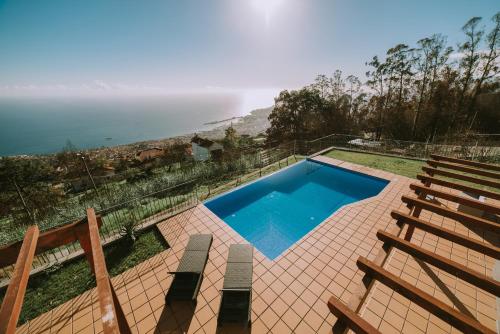 a swimming pool with a view of the ocean at Ocean View Villa in Funchal