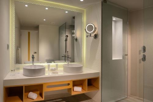a bathroom with two sinks and a large mirror at Catalonia Yucatan Beach - All Inclusive in Puerto Aventuras