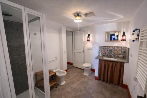 a bathroom with a toilet and a sink and a shower at Exclusive Villa - Relax - A-C - Stunning View in Porto Ercole