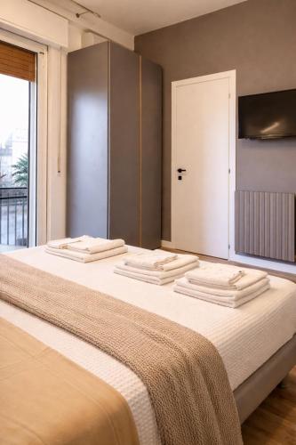 a bedroom with a large bed with a large window at A Due Passi Dalla Scalinata Rooms in Caltagirone