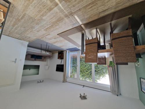 a room with a large window and wooden ceilings at Ferienwohnung Zürcher in Chieming
