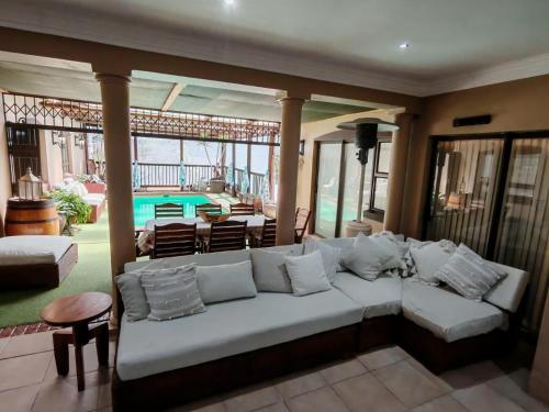 a living room with a white couch and a pool at Merensee in Langebaan
