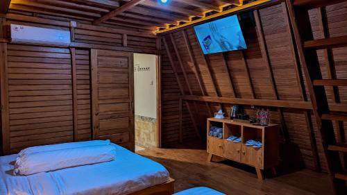 a room with two beds and a flat screen tv at Villa de Gema in Selabintana
