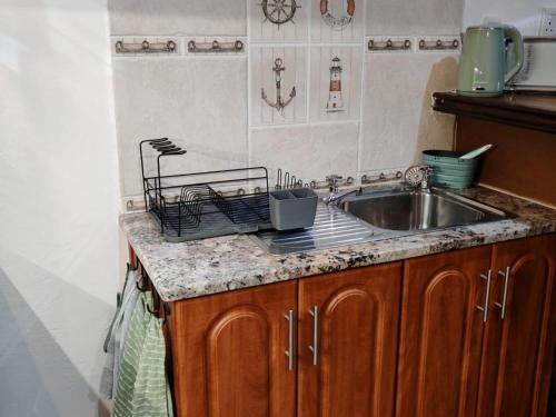 a kitchen with a sink and a counter top at Merensee in Langebaan
