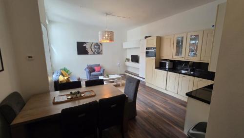 a kitchen and living room with a table and a dining room at Perfectly Located, Surprisingly Quiet in Gouda