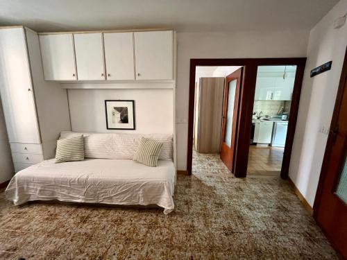 a bedroom with a bed and a hallway with a kitchen at RioRooms La Valletta Riomaggiore Center in Riomaggiore
