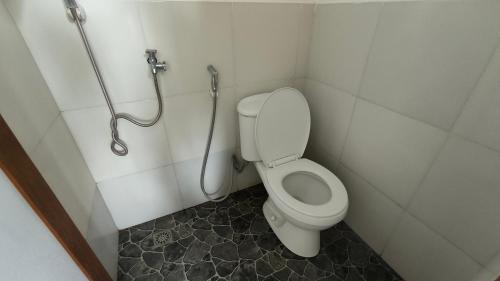 a bathroom with a toilet and a shower at Mentari Ocean View Resort in Tamperan