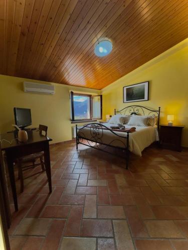 a bedroom with a bed and a wooden ceiling at Locanda del Castello in Frontone
