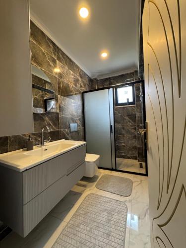 a bathroom with a sink and a toilet and a shower at Yeşilyurt villa in Sapanca