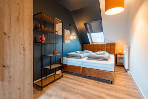a bedroom with a bed and a book shelf at Laras Loft in Leipzig