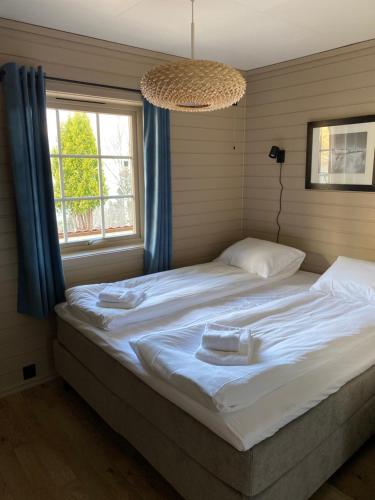 a bedroom with a bed with two towels on it at Charming view in Olden