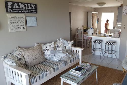 a living room with a couch and a table at Strandloper Apartments in Hermanus
