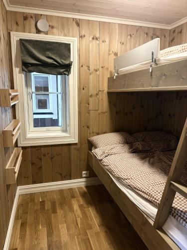 a small room with a bunk bed and a window at Lastølen Snr6 nr2 in Sykkylven