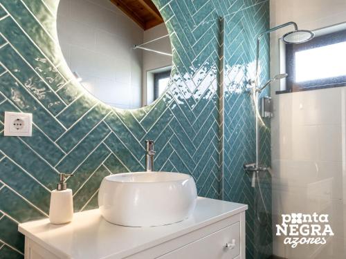 a bathroom with a sink and a mirror at Bird House by PontaNegraAzores in Altares