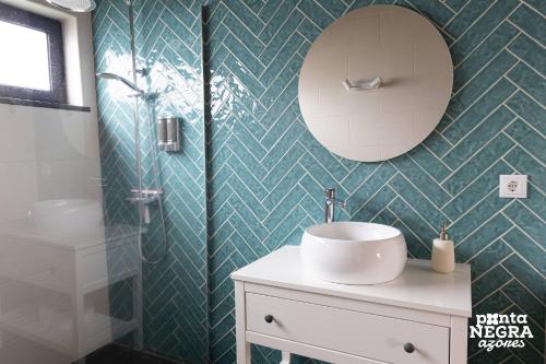 a bathroom with a sink and a mirror at Photography House by PontaNegraAzores in Altares