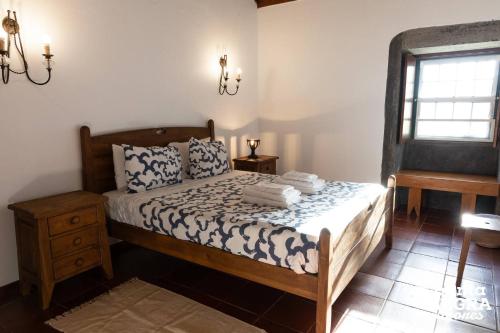 a bedroom with a bed and a window at Casa das Vaquinhas by Ponta Negra Azores in Altares
