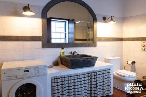 a bathroom with a sink and a washing machine at Casa das Vaquinhas by Ponta Negra Azores in Altares