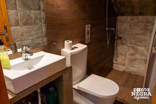 a bathroom with a sink and a toilet and a shower at The North House by Ponta Negra Azores in Biscoitos