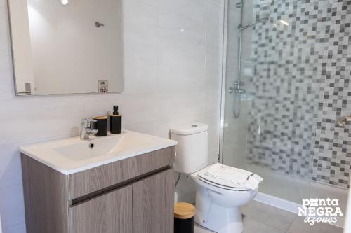 a bathroom with a toilet and a sink and a shower at Casa da Gente by PontaNegraAzores in Biscoitos