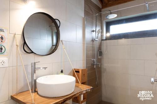 a bathroom with a sink and a mirror at Wine House by Ponta Negra Azores in Altares
