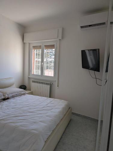 a bedroom with a bed and a flat screen tv at b&b la terrazza in Lido dei Pini