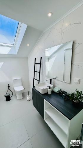 a bathroom with a sink and a toilet at City House by PontaNegraAzores in Angra do Heroísmo