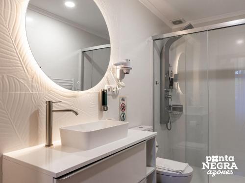 a bathroom with a sink and a shower at Quinta de São José by PontaNegraAzores in Angra do Heroísmo