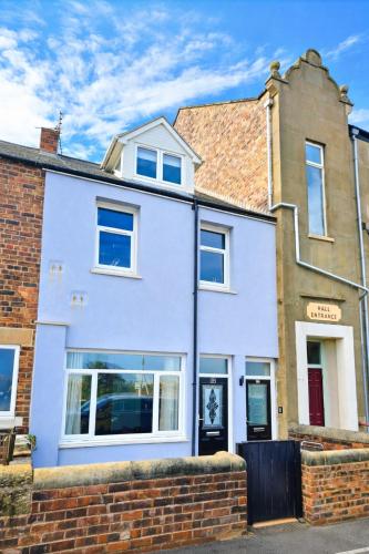 a white house with a brick at Seaside Cambois Apartment in Cambois