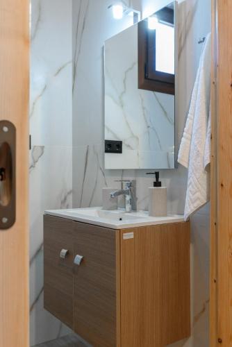 a bathroom with a sink and a mirror at Eudokia's House Platanias in Platanias