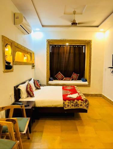 a bedroom with a bed with a large window at Hostel stay bless in Jaisalmer