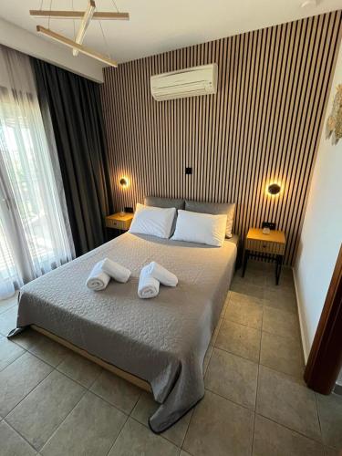 a bedroom with a bed with two towels on it at Domus Afitos in Afitos