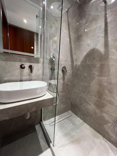 a bathroom with a sink and a glass shower at Domus Afitos in Afitos