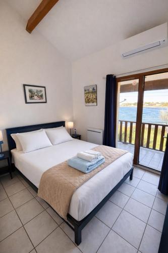 a bedroom with a bed with a view of the ocean at La mer en liberté in Gruissan