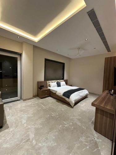a large bedroom with a bed and a large window at ANANTYA BANQUET and HOTEL in Sonīpat