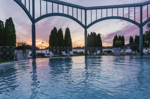 a swimming pool with a sunset in the background at Naantali Spa Hotel in Naantali