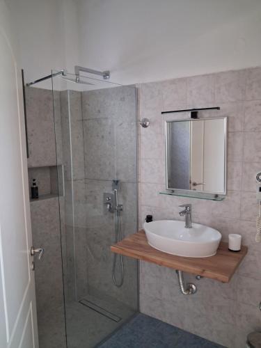 a bathroom with a sink and a shower at Elia Studios in Palekastron