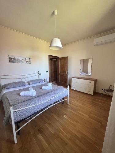 a bedroom with a bed with two towels on it at Villa Giulia apartment Assisi in Castelnuovo